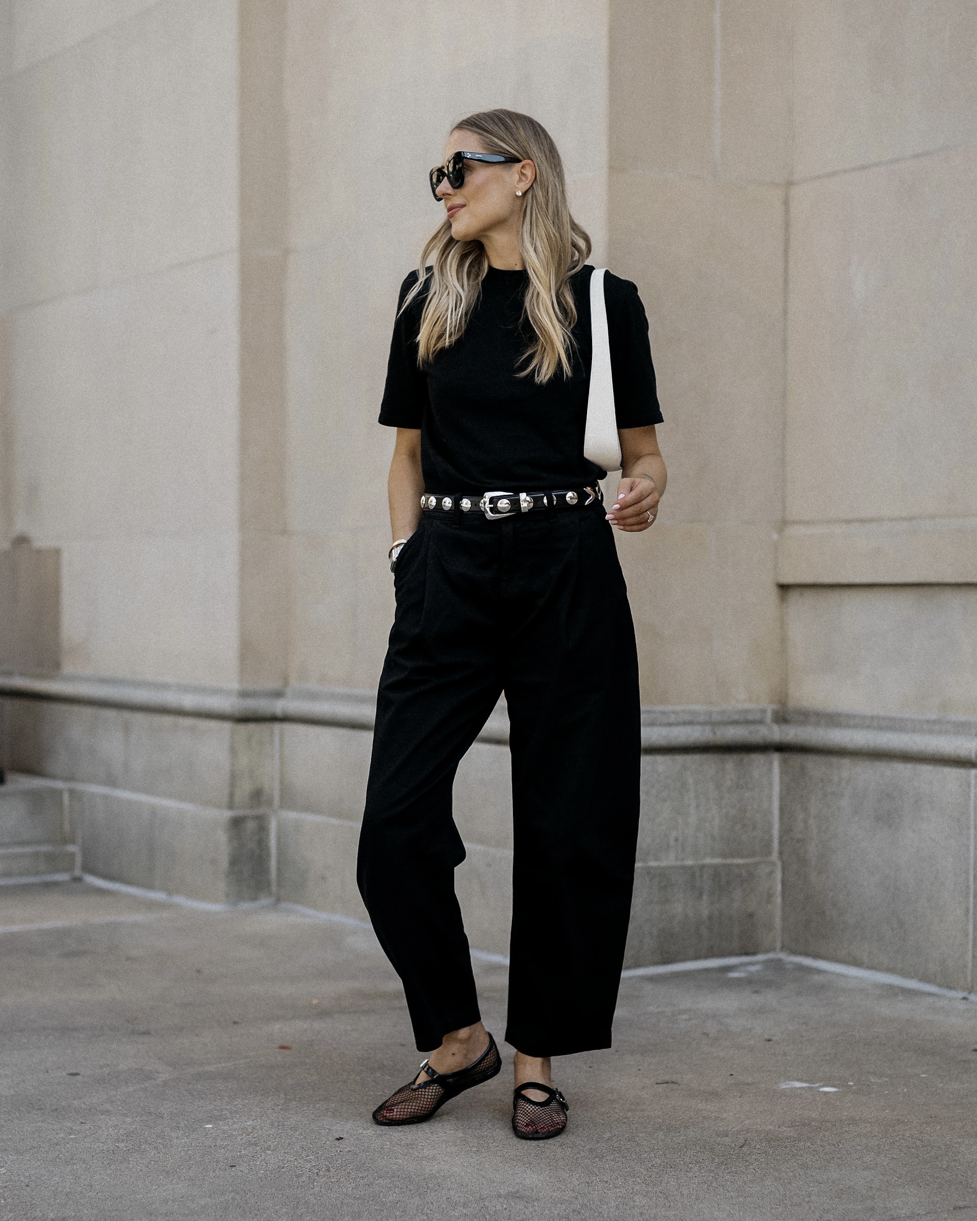 Black short sleeve top with black wide-leg trousers