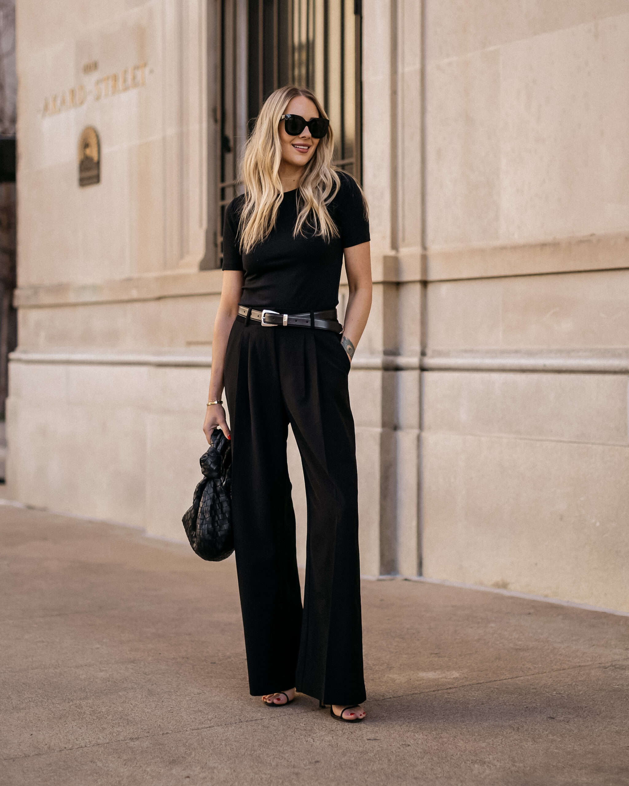 Black sleeveless top and high-waisted wide-leg black trousers