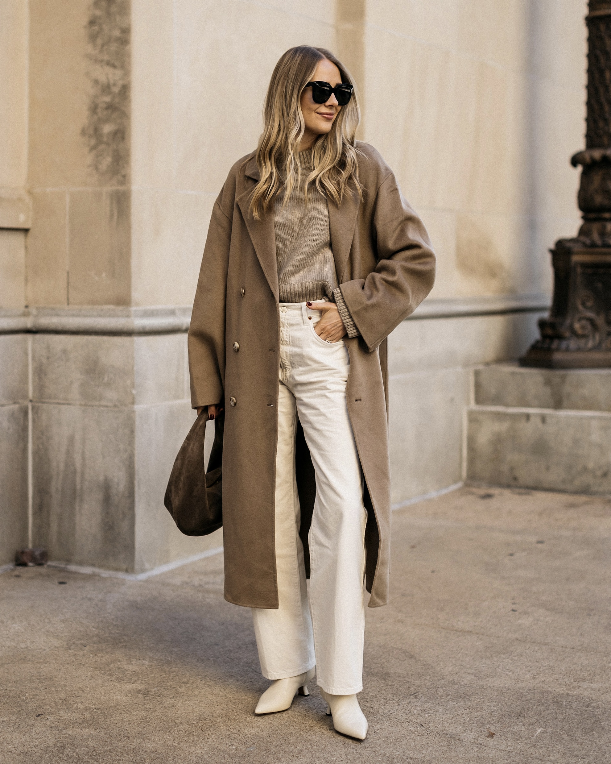 Taupe sweater with cream trousers, light shoes and a dark shoulder bag